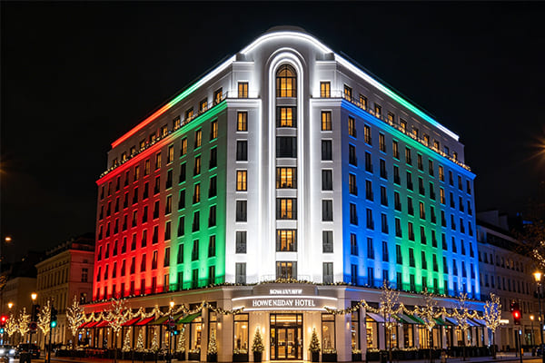 a landmark hotel with elegant white and festive color lighting